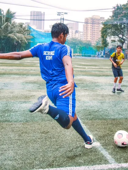 A player from our U-16 team follows through on a powerful shot during a match. This photo highlights the proper shooting form and technique we teach at the academy.