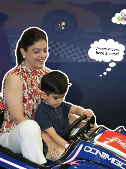 Vroom vroom, here I come! A mother and son share a special moment, ready to race and bump their way through our exciting track. It's the perfect bonding activity.