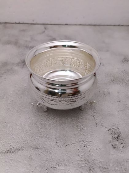 A simple and elegant German silver bowl with three small legs, perfect for holding offerings.