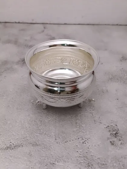 A small German silver bowl with three legs, featuring delicate engravings. Ideal for holding kumkum, chandan, or akshat.