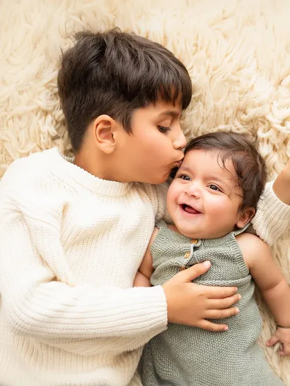 A big brother's gentle kiss for his baby sibling. These are the candid, heartwarming moments that you will treasure for a lifetime.