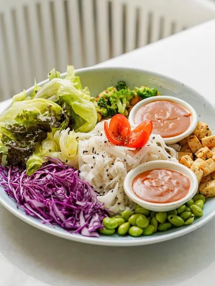 A colorful and healthy Buddha bowl. The composition is balanced, and the vibrant colors of the fresh vegetables make the dish look incredibly appealing and nutritious.