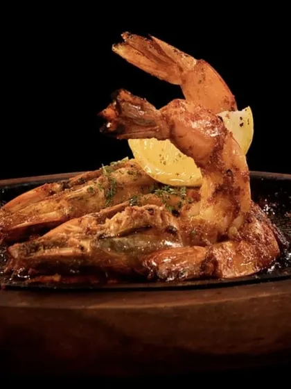 Sizzling garlic prawns, or Gambas al Ajillo, served hot from the pan. The aroma of garlic, chili, and olive oil is intoxicating.