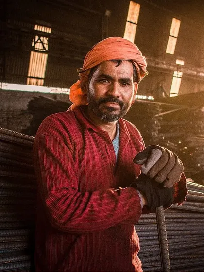 For me, photography is about finding beauty everywhere. This portrait of a worker, captured in the golden light of a factory, shows the power of authentic, environmental portraiture.