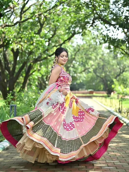 A playful and vibrant patchwork lehenga with a full flare, perfect for a twirl. The mix of pink, yellow, and green with traditional motifs makes this a standout choice for a Mehendi or Sangeet function.
