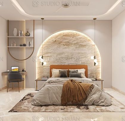 This bedroom features a unique arched alcove behind the bed, finished in a textured stone-like material and backlit to create a beautiful halo effect. A sleek, wall-mounted desk provides a functional workspace.