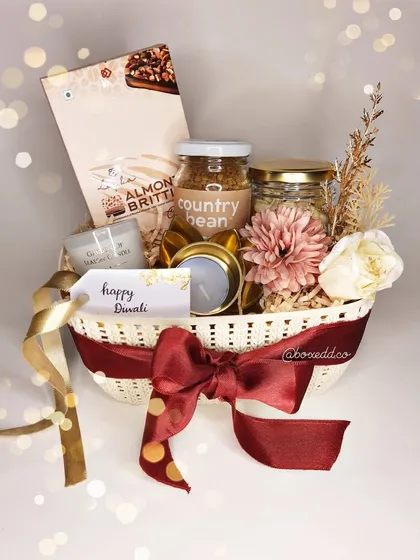 A beautifully styled shot of one of our Diwali gift baskets, with a soft, glowing background that evokes the warmth and light of the festival.