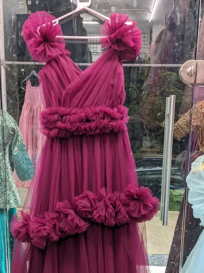 This beautiful magenta gown with fabric flower details is a perfect photoshoot dress, whether for a pre-wedding, maternity, or fashion shoot.