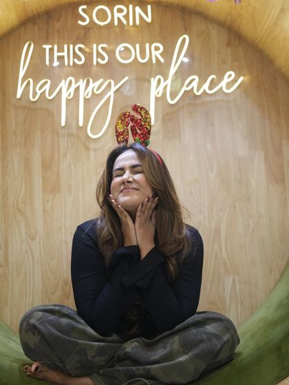 A happy client showing off her fresh, bouncy hairstyle. Her smile and radiant look are the best rewards.