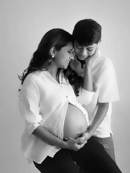 A black and white version of a tender moment between a mother and her firstborn. He looks at her belly with such curiosity and love, ready to be a big brother.