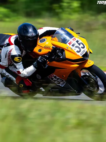 A motion-blurred shot capturing the pure speed and focus of a rider on a straight. While cornering is key, I also teach throttle control and acceleration techniques for maximum performance.