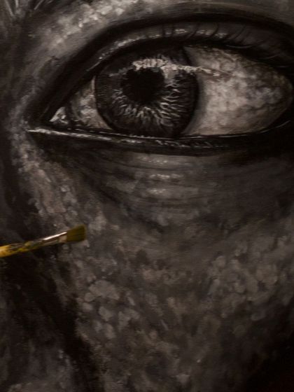 A macro shot of the brushwork on the eye. The texture is built up with many layers of black, white, and grey acrylics to create a sense of realism and depth.