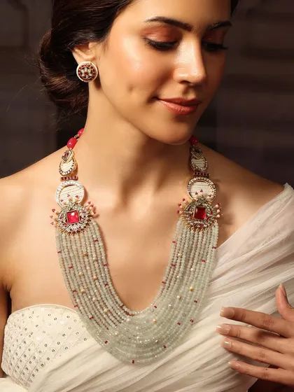 A unique heritage piece featuring a multi-strand beaded necklace with striking red accents and traditional motifs.