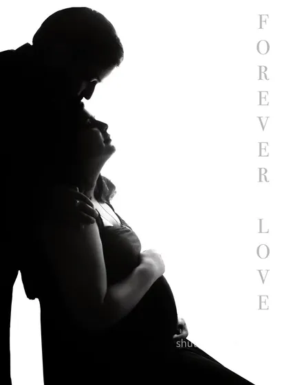 "Forever Love." This intimate silhouette captures a tender moment as the father-to-be kisses his partner's forehead. The high-contrast lighting creates a timeless and romantic fine-art portrait.