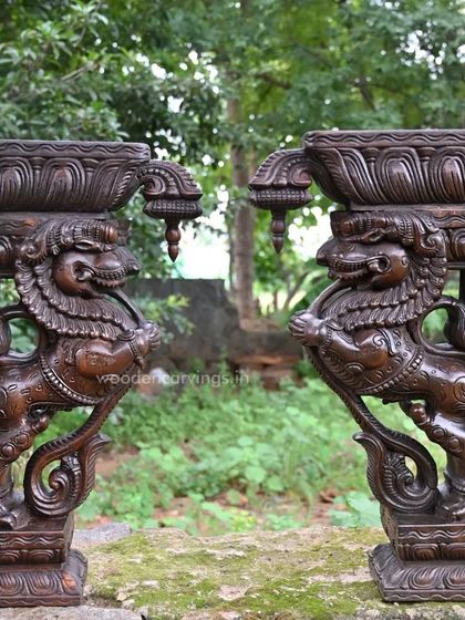 A pair of 24-inch Yaazhi brackets with a rich, dark finish, displayed outdoors. This image shows their robust form and the deep shadows that highlight the intricate carving work, perfect for both interior and exterior decor.