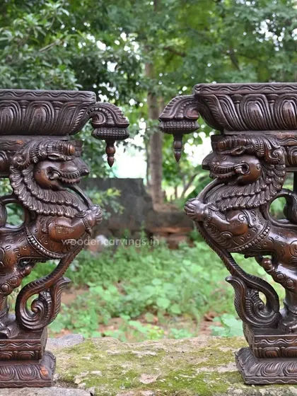 A pair of 24-inch Yaazhi brackets with a rich, dark finish, displayed outdoors. This image shows their robust form and the deep shadows that highlight the intricate carving work, perfect for both interior and exterior decor.