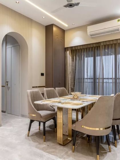 A harmonious blend of luxury and tranquility, this dining space is crafted to inspire intimate gatherings. The marble-top table with gilded accents and plush seating exude opulence, while a large spiritual art piece creates a calming sanctuary.