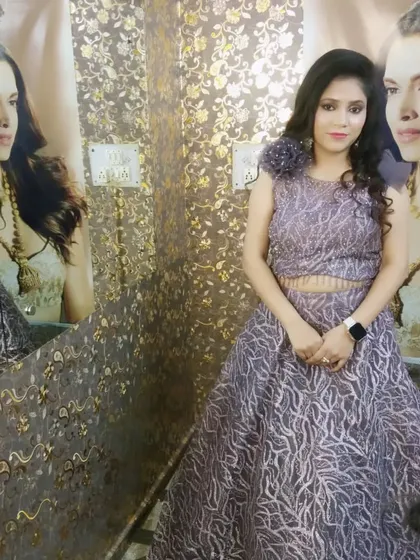 The full view of the party look, showing the beautiful grey gown. The makeup and hair are designed to complement the elegant outfit.