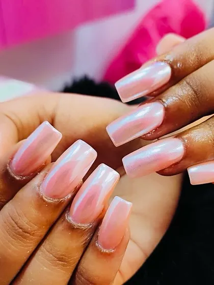 The perfect glazed donut look. These square-shaped nails have a soft, iridescent pink chrome finish that creates a beautiful, pearly shine that's both trendy and elegant.