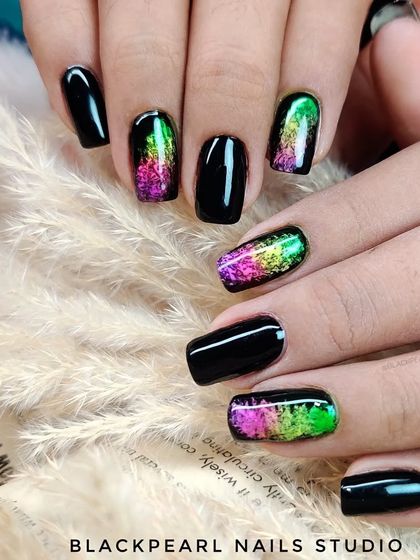 A full view of the pigment art on black nails, showcasing a design that is both edgy and artistic.