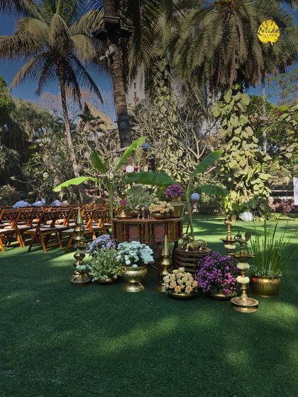 This traditional decor setup, featuring brass lamps and local flowers, perfectly complements the natural, tropical vibe of our palm-fringed lawns for a classic South Indian wedding.
