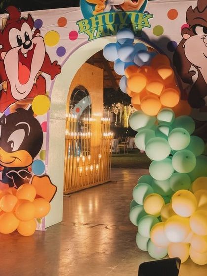 A fun and colorful entrance with Taz and Daffy cutouts welcoming guests to the Looney Tunes celebration.