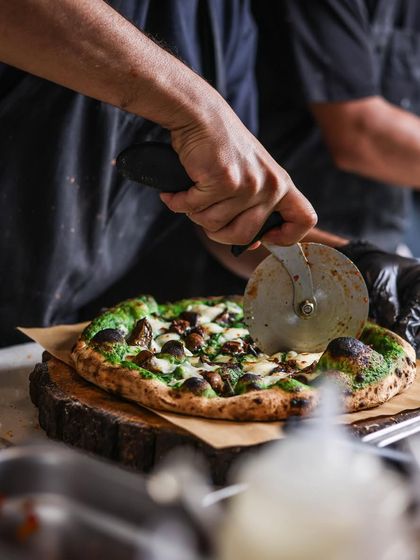 It’s the day after Christmas, so relax and enjoy some delicious pizzas. This mushroom and spinach cream pizza is ready for slicing.