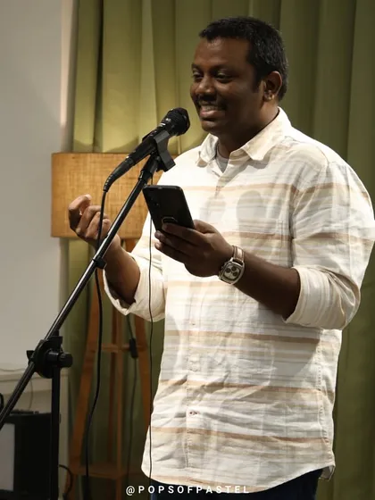 An artist shares a story, using hand gestures to bring it to life.