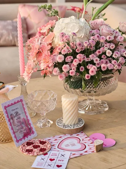 It's all about the little things. For this tablescape, I curated a collection of personalized love notes, playful coasters, and floral arrangements to make every guest feel special.