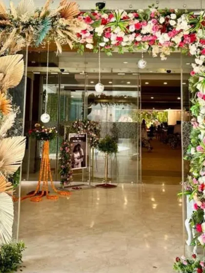 I enjoy mixing modern trends with classic flowers. This entrance arch combines trendy dried pampas grass with fresh, colorful roses and other flowers to create a warm and welcoming feel for a daytime event.