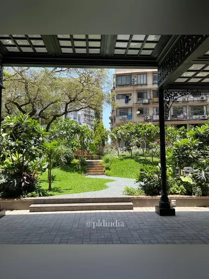 Looking out from an ornate, covered patio, the garden is framed as a living work of art. This perspective highlights how I design landscapes to be enjoyed from both within and outside the built structure, creating a seamless connection to nature.