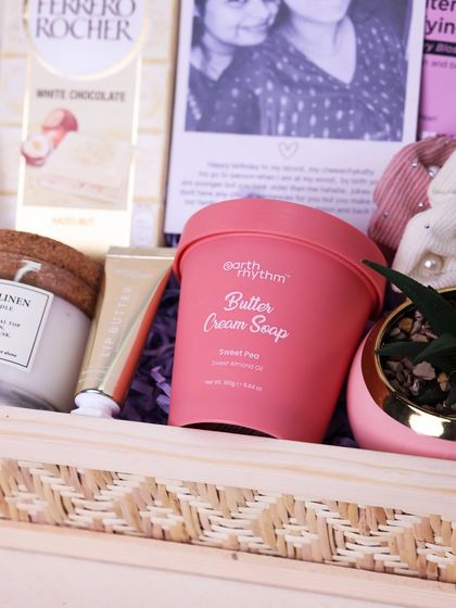 A detail shot of the curated items in the sister hamper, showing the blend of sweet treats and relaxing products.