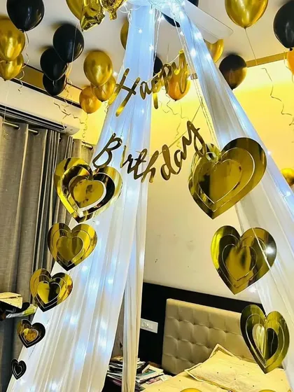 This view highlights the golden heart-shaped cutouts hanging inside the fairy light canopy, adding a touch of glamour.