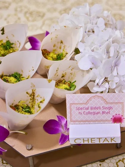 A taste of Mumbai's streets, elegantly served. Our Special Baleli Singh ni Collegian Bhel is presented in paper cones, making it a fun and easy-to-eat snack for guests.
