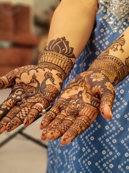 A gorgeous design for a bridesmaid, featuring majestic peacocks on the palms. The surrounding patterns are intricate and traditional, making it a perfect choice for a wedding celebration.