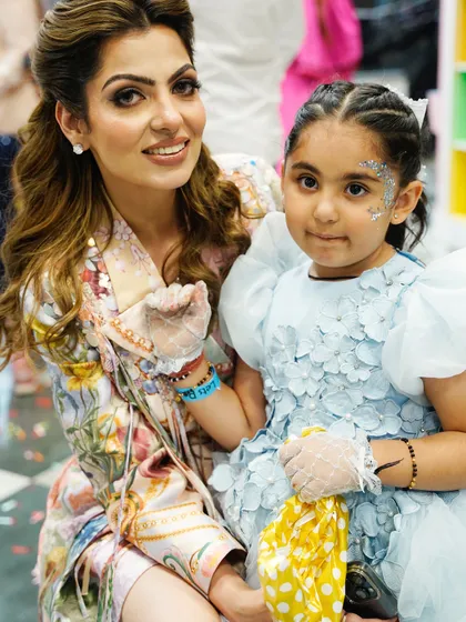 A mother and daughter show off the beautiful glitter face paint. It's a fun and creative activity that kids love.