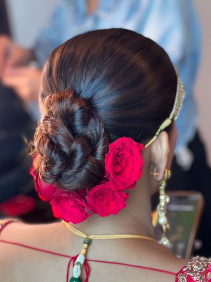 Another angle of the braided rose bun, showing how it can be paired with a matha patti for a complete bridal look.