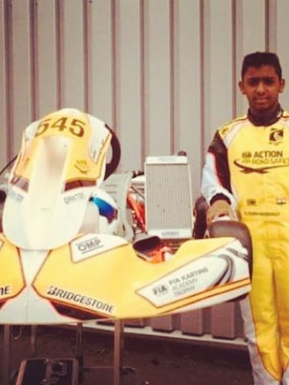 Our driver standing proudly with his kart at the FIA Karting Academy Trophy, ready to compete against the world's best.