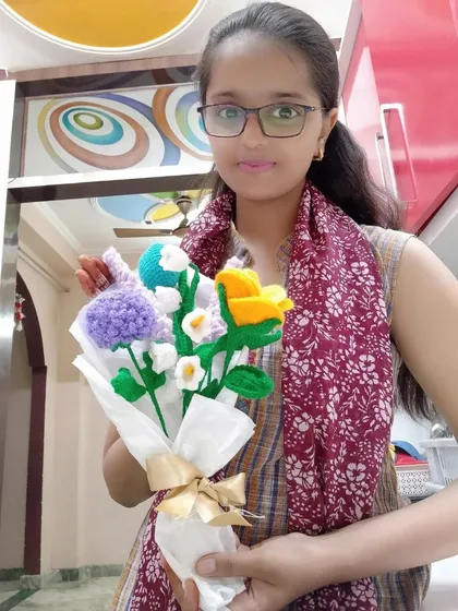 Holding a custom mixed bouquet featuring lavender, daisies, and other colorful flowers. We can create a personalized arrangement with any combination of your favorite blooms.