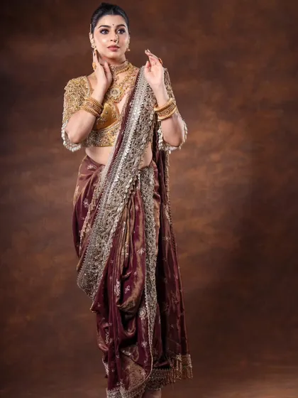 Another full-length pose that captures the rich texture and fall of the traditional saree, perfect for a designer catalog.
