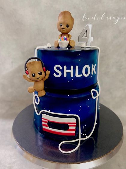 Baby Groot is here to rock out! This galaxy-themed cake features two adorable, handmade Baby Groot figurines, one listening to music and one enjoying some candy. It was a blast to make for a Guardians of the Galaxy fan.