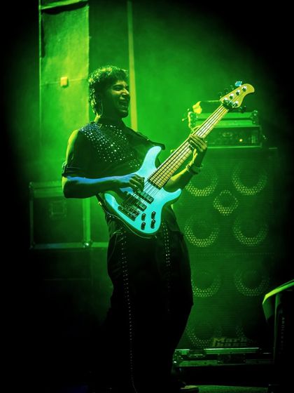 Our bassist, bathed in green light, laying down the solid foundation of our groove.