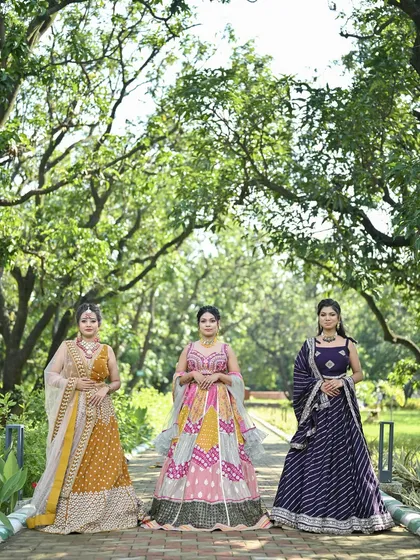 A trio of our festive lehengas. This photo displays a mustard yellow, a pink patchwork, and a purple leheriya lehenga, highlighting the variety in our collection.