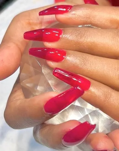 Real red. A classic, bold red manicure on long, coffin-shaped jelly nails for a slightly translucent, high-shine finish.
