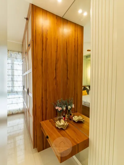 Another angle of the fabric-paneled wardrobe, showing how it integrates with a compact, floating dressing table. This cohesive design ensures every inch of the bedroom is both beautiful and functional.