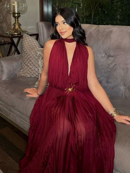 Serving looks from head to toe. Sana is the picture of modern glamour in this full-length shot, with her bronzed makeup perfectly complementing her elegant red dress.