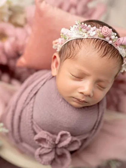 A close-up of this beautiful angel, showing the delicate details of the floral wrap and headband.