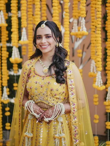Haldi calls for a pop of color! I love experimenting with vibrant looks for pre wedding functions. For Dr. Archita, we went with a stunning pink eyeshadow to complement her yellow outfit, creating a fresh and playful look that stood out beautifully against the marigold decor.