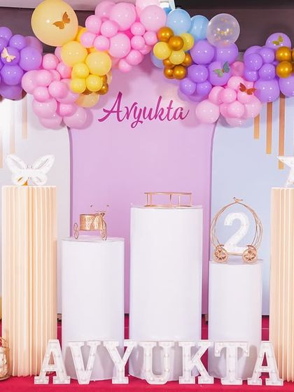 A thrilling 'Hot Wheels' themed birthday party, with checkered flags, car cutouts, and a custom racetrack backdrop, perfect for little speed enthusiasts.