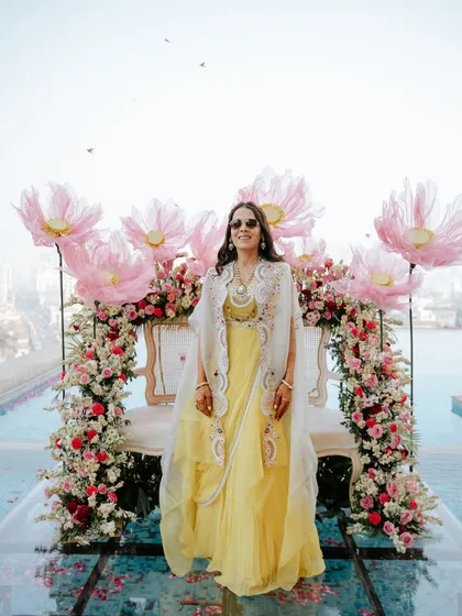 A guest looking effortlessly chic against our floral backdrop. We design spaces that make everyone feel and look their best.